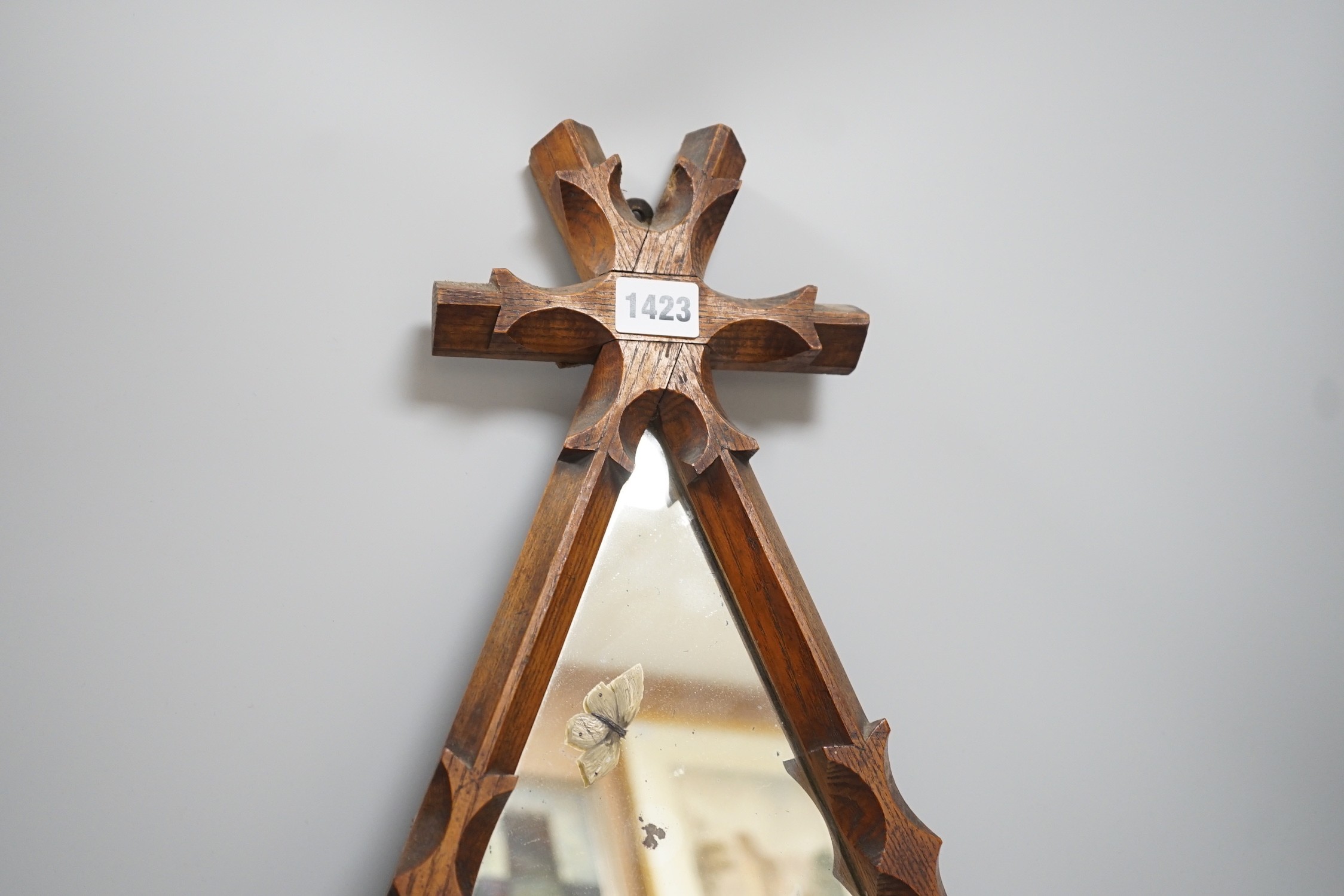 A reformed Gothic oak framed ‘swan’ painted mirror, 55cm tall